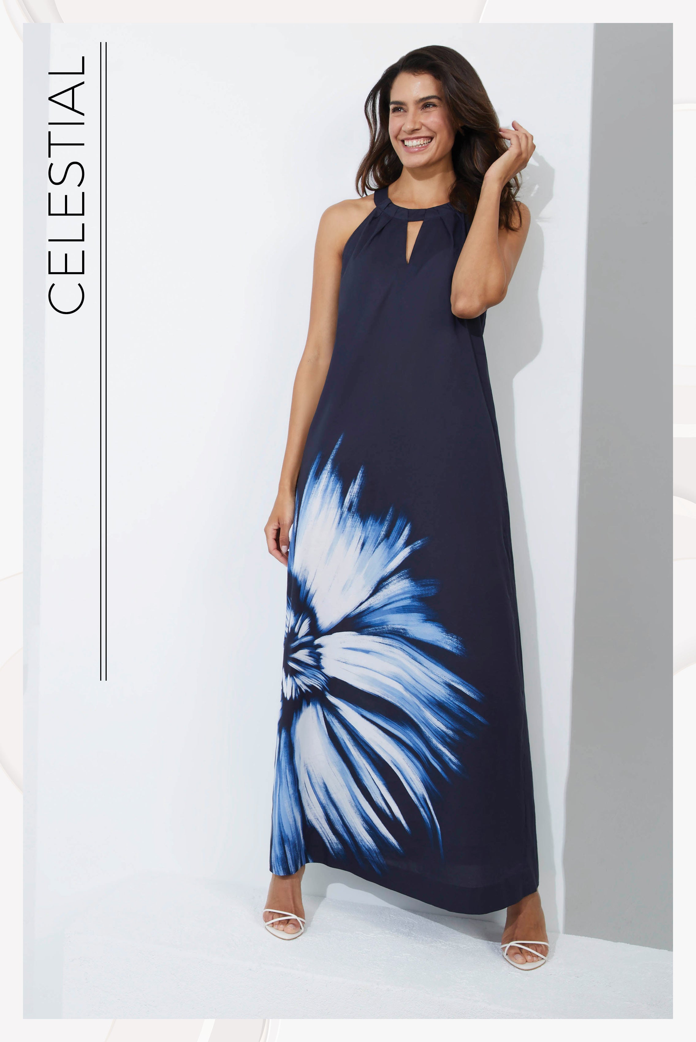 Photo of a model wearing the Celestial dress, a floral print cotton voile halter maxi dress.