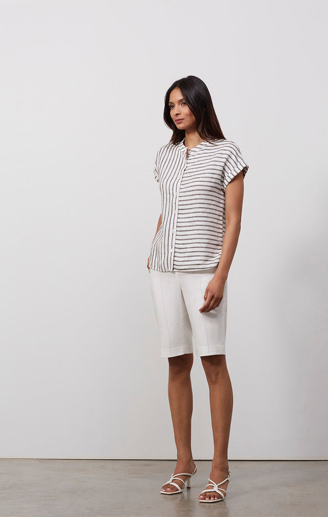 Ecomm photo of a model wearing the Frontier shirt, which is a striped linen shirt.