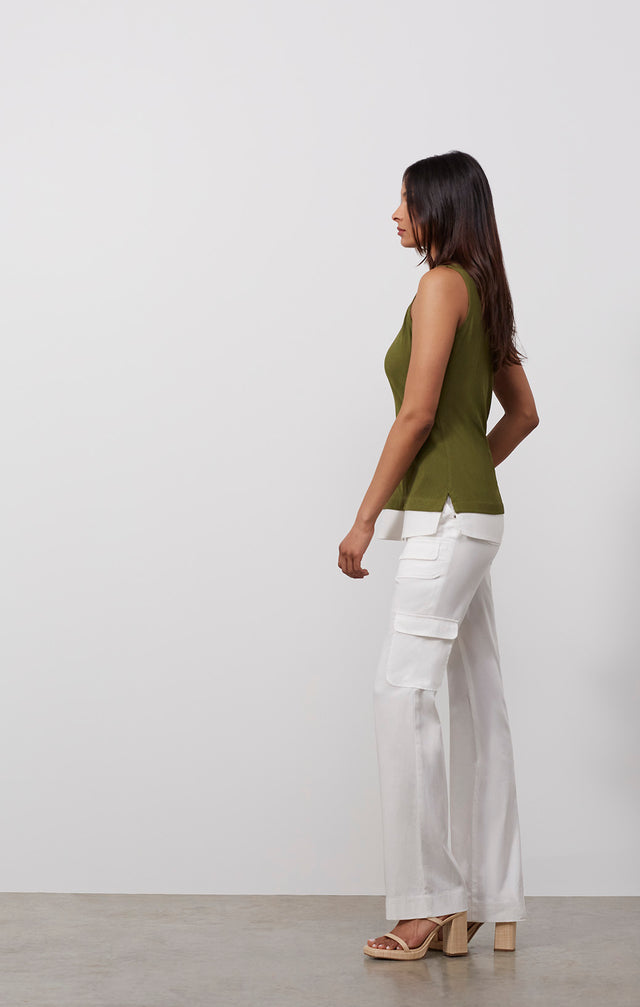 Ecomm photo of a model wearing the Areca shell,  which is a sleeveless knit tank top.
