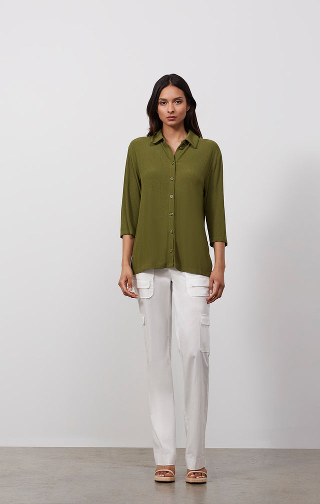 Ecomm photo of a model wearing the Areca shirt, which is a high-low knit tunic with side slits.