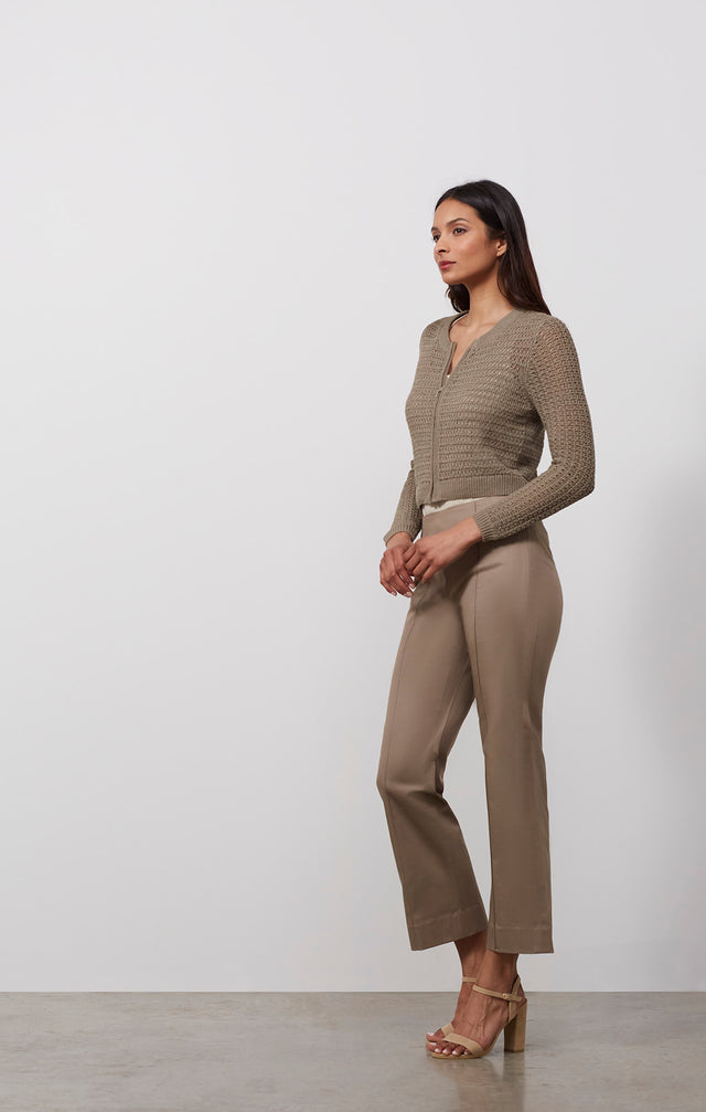  Ecomm photo of a model wearing the Tajine sweater, which is a linen-blend knit cardigan.