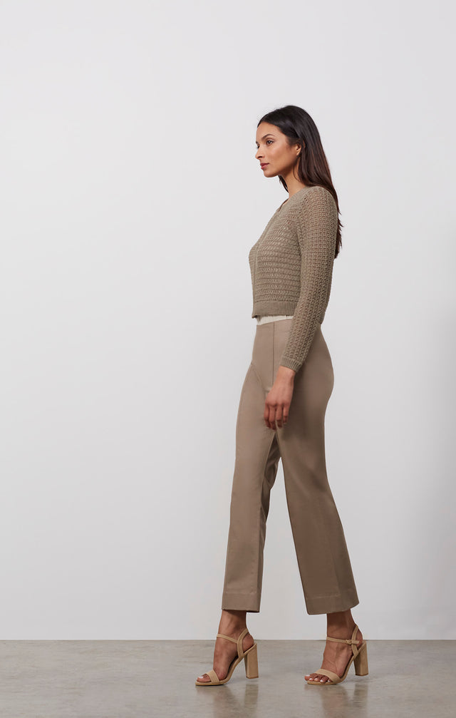 Ecomm photo of a model wearing the Tajine sweater, which is a linen-blend knit cardigan.