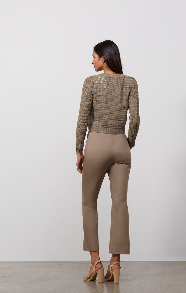 Ecomm photo of a model wearing the Tajine sweater, which is a linen-blend knit cardigan.