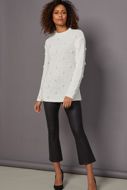 Lookbook photo of model wearing Buttercream sweater with cute pearls on it.