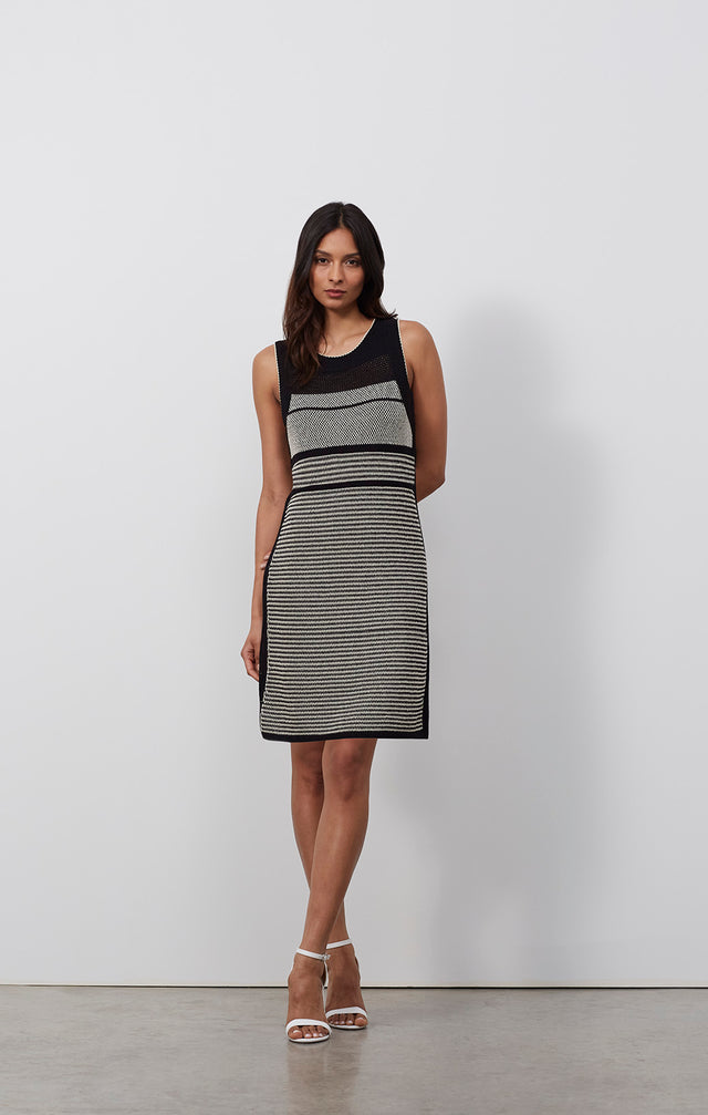 Ecomm photo of a model wearing the Sandpiper dress, which is a striped linen-blend knit tank dress.