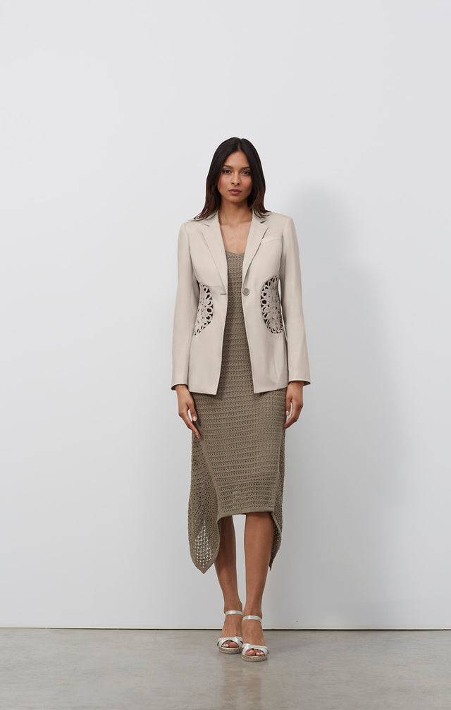 Ecomm photo of a model wearing the Sand Dollar jacket, which is a tailored blazer with open crochet.