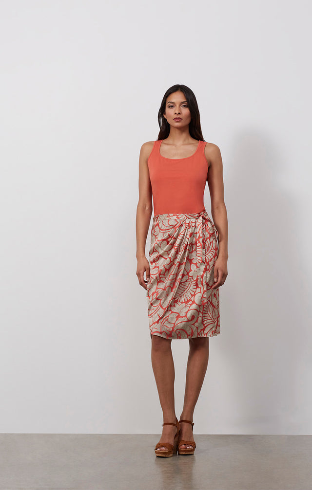 Ecomm photo of a model wearing the Tahiti skirt, which is a sarong wrap skirt in stretch sIlk satin.