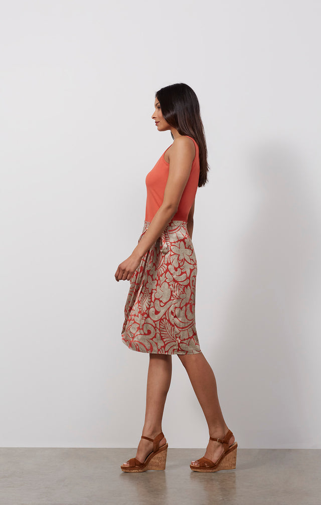 Ecomm photo of a model wearing the Tahiti skirt, which is a sarong wrap skirt in stretch sIlk satin.