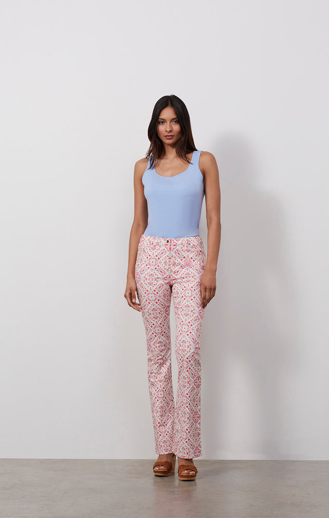 Ecomm photo of a model wearing the Spice pants, which is jeans in a placed Moroccan tile print.