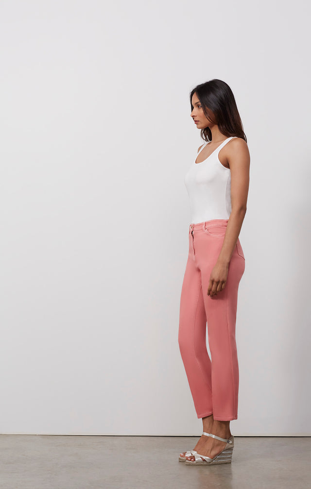 Ecomm photo of a model wearing the Trieste pants, which is a wash-softened pink denim jeans.