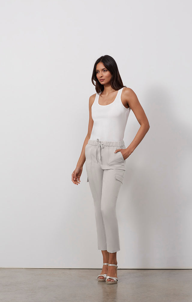 Ecomm photo of a model wearing the Capitola pants, which is a stretch utility travel pants.