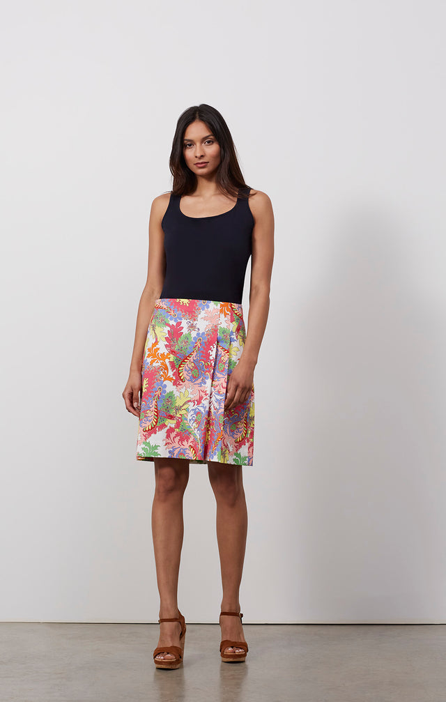 Ecomm photo of a model wearing the Oasis skirt, which is a pleated skirt in a Moroccan foliage print.