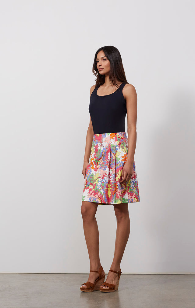 Ecomm photo of a model wearing the Oasis skirt, which is a pleated skirt in a Moroccan foliage print.