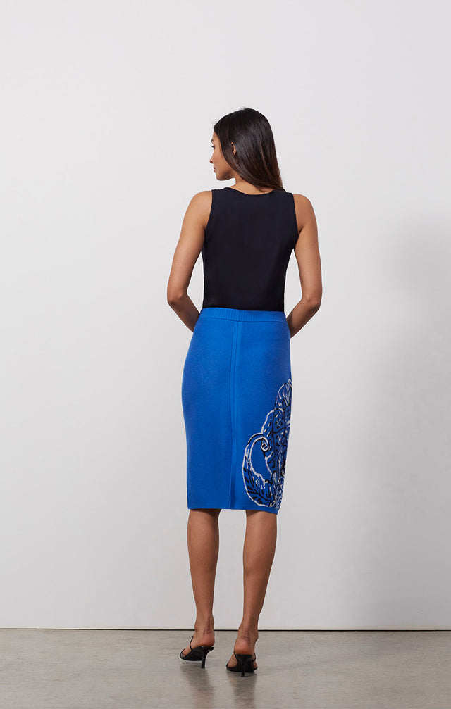 Ecomm photo of a model wearing the Frond skirt, which is a placed floral jacquard knit skirt.