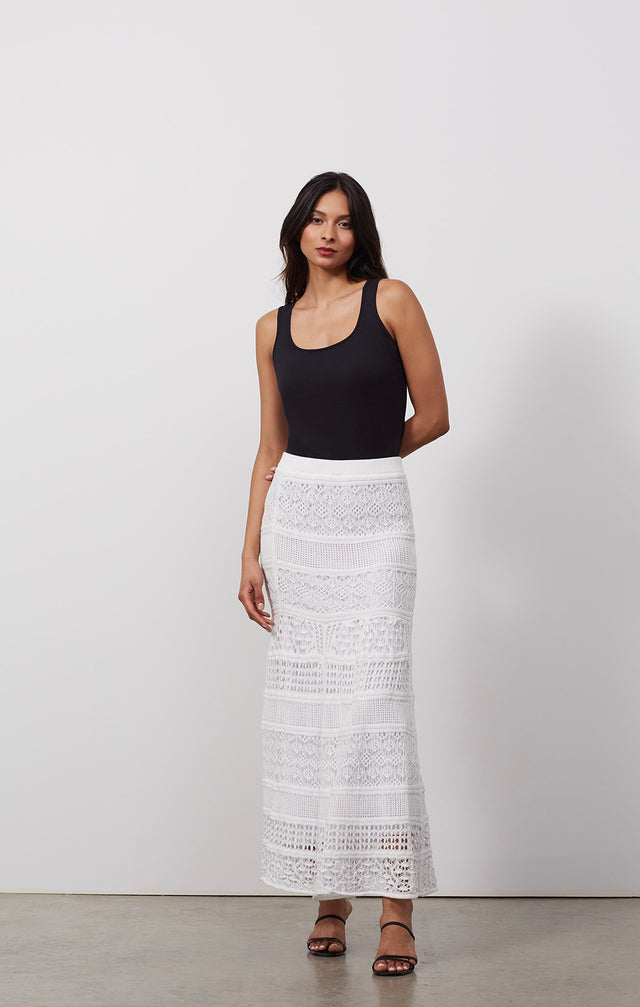 Ecomm photo of a model wearing the Tracery skirt, which  is a lace-look pull-on knit maxi skirt.