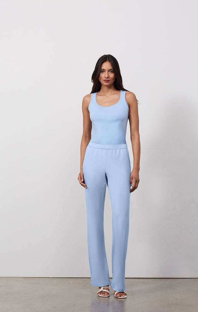 Ecomm photo of a model wearing the Passage-Blu pants, which is a blue pull-on Jersey knit lounge pants.