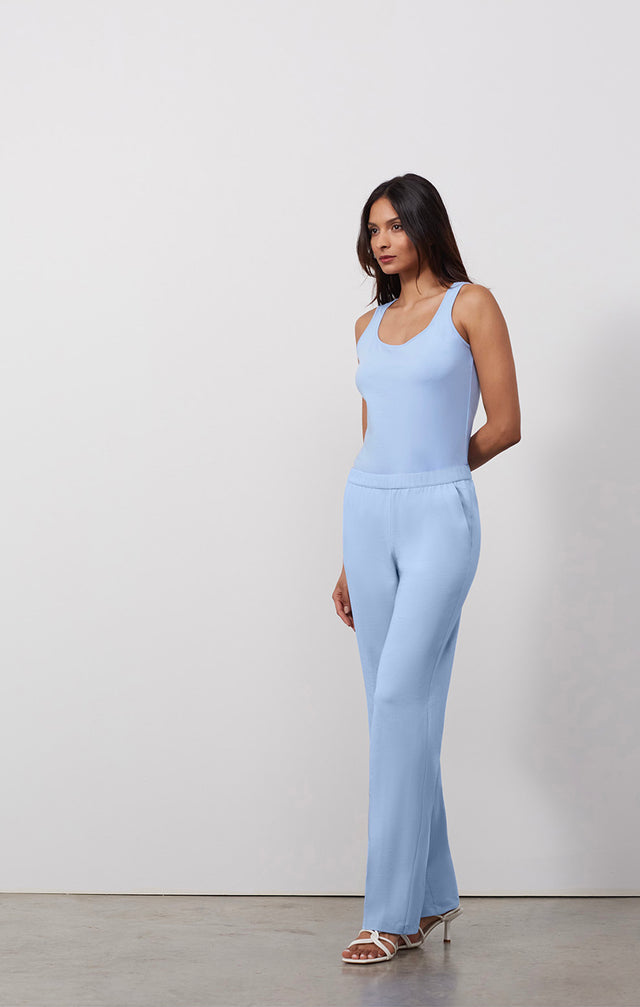 Ecomm photo of a model wearing the Passage-Blu pants, which is a blue pull-on Jersey knit lounge pants.