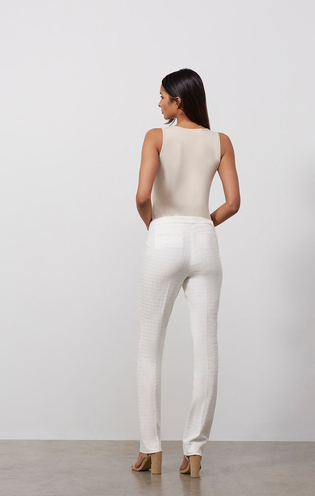 Ecomm photo of a model wearing the Baskerville pants, which is a white trousers in stretch houndstooth jacquard .