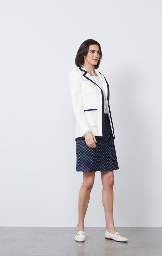 Ecom photo of model wearing the Agora jacket and the Surging skirt