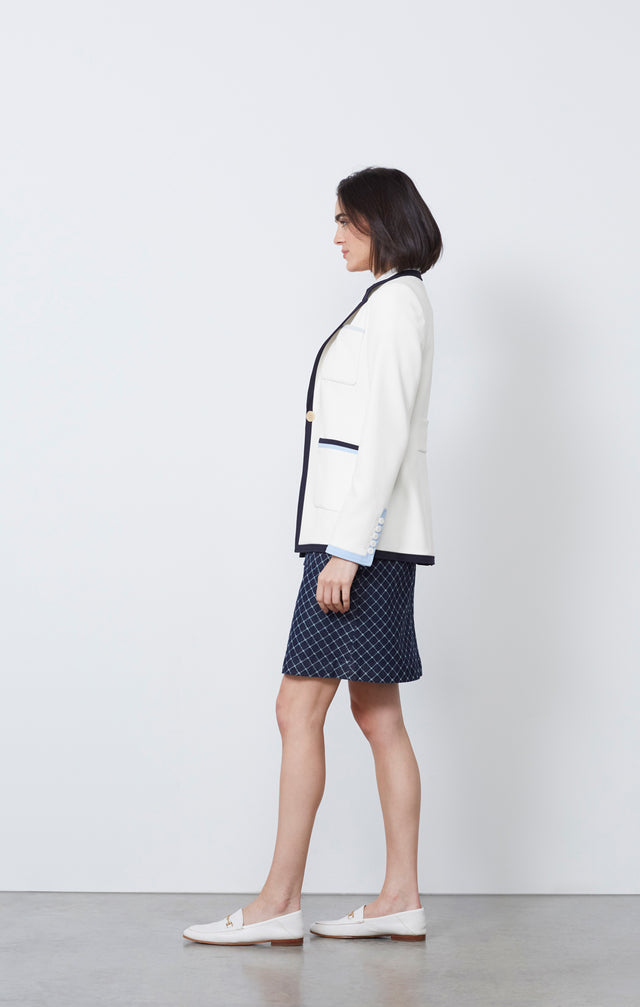 Ecom photo of model wearing the Agora jacket and the Surging skirt