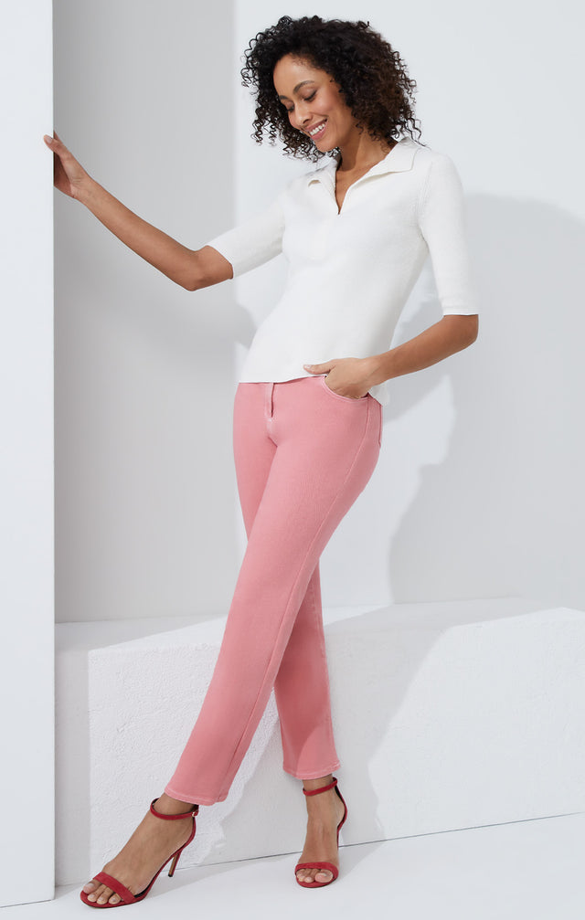 Lookbook photo of a model wearing the Trieste pants, which is a wash-softened pink denim jeans.