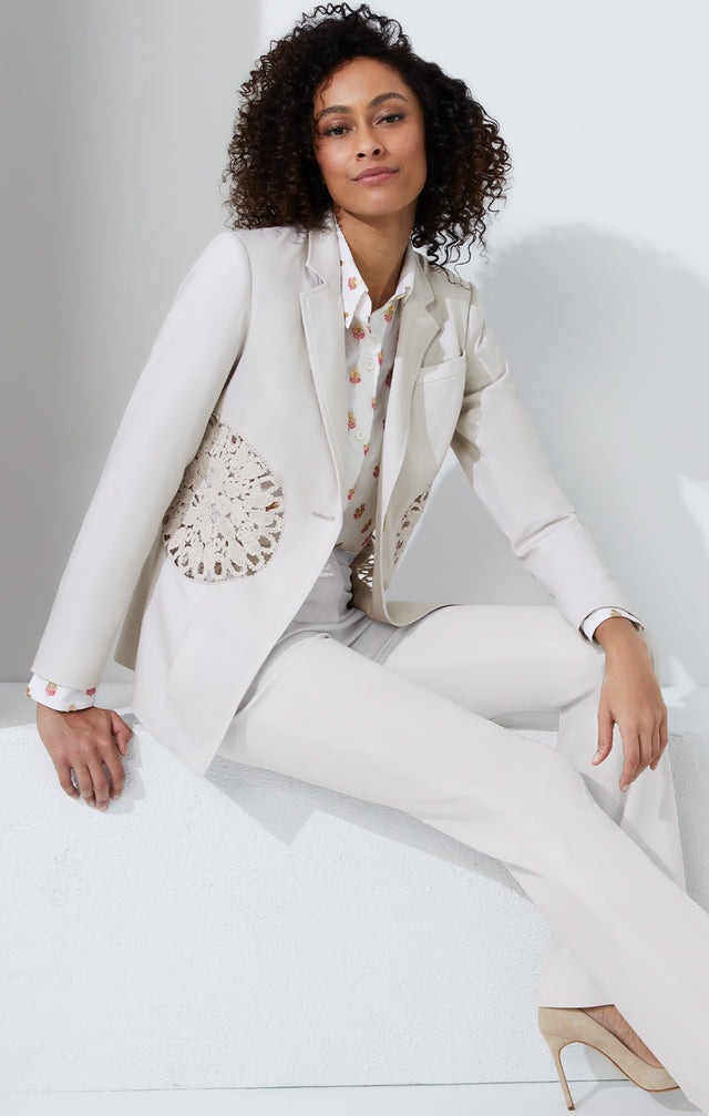 Lookbook photo of a model wearing the Sand Dollar jacket, which is a tailored blazer with open crochet.
